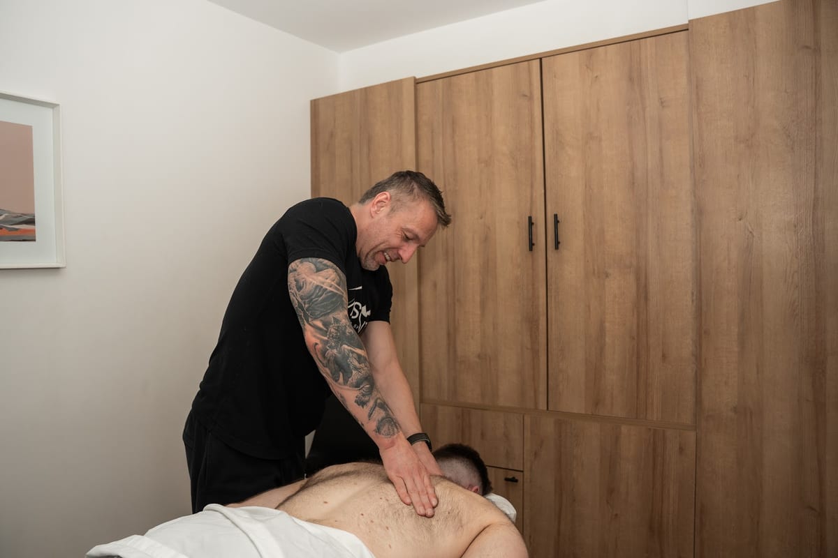 A registered massage therapist working on a patient's back at the Capitol Hill clinic