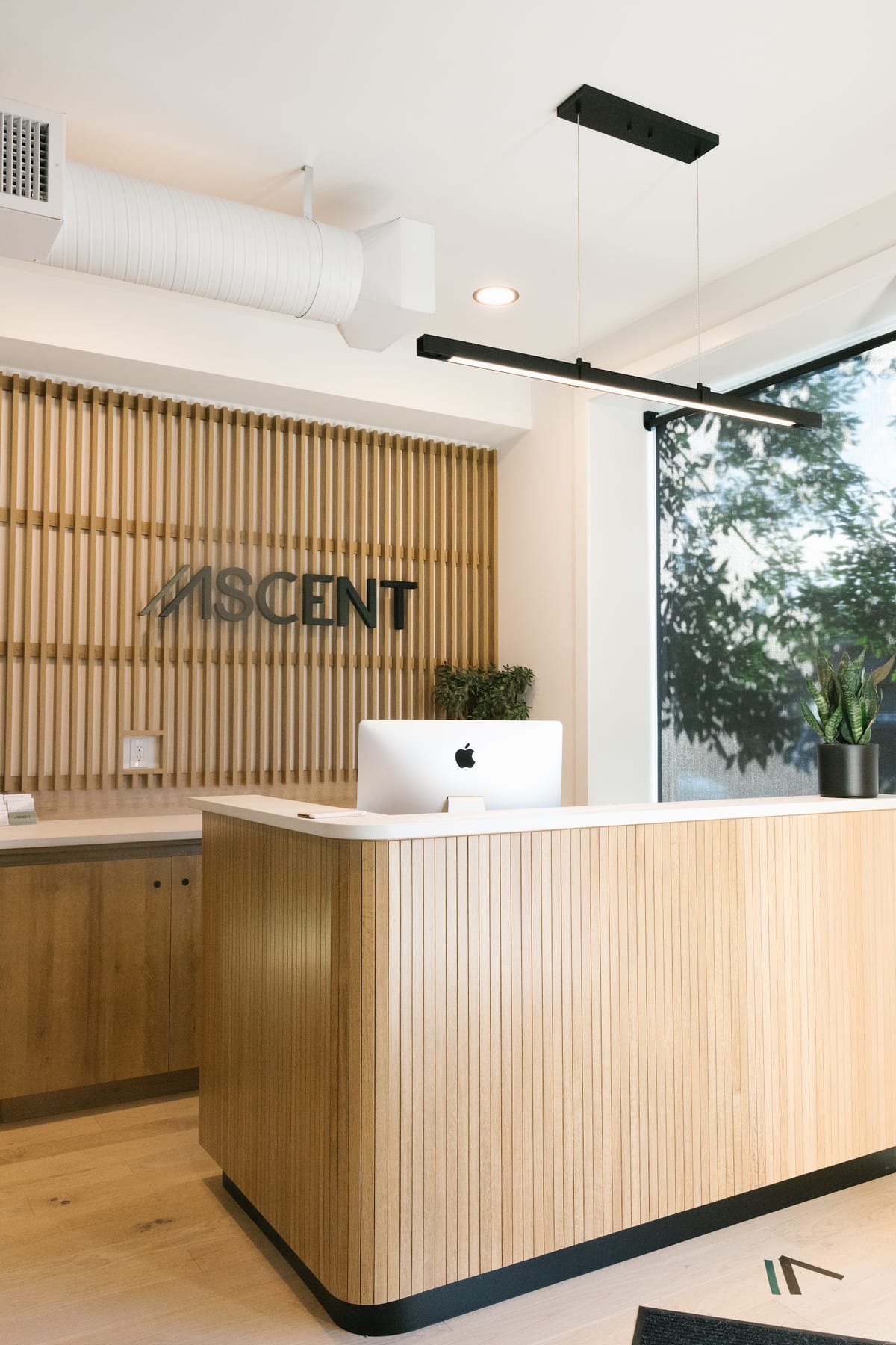 The Ascent wordmark above the reception desk at Capitol Hill